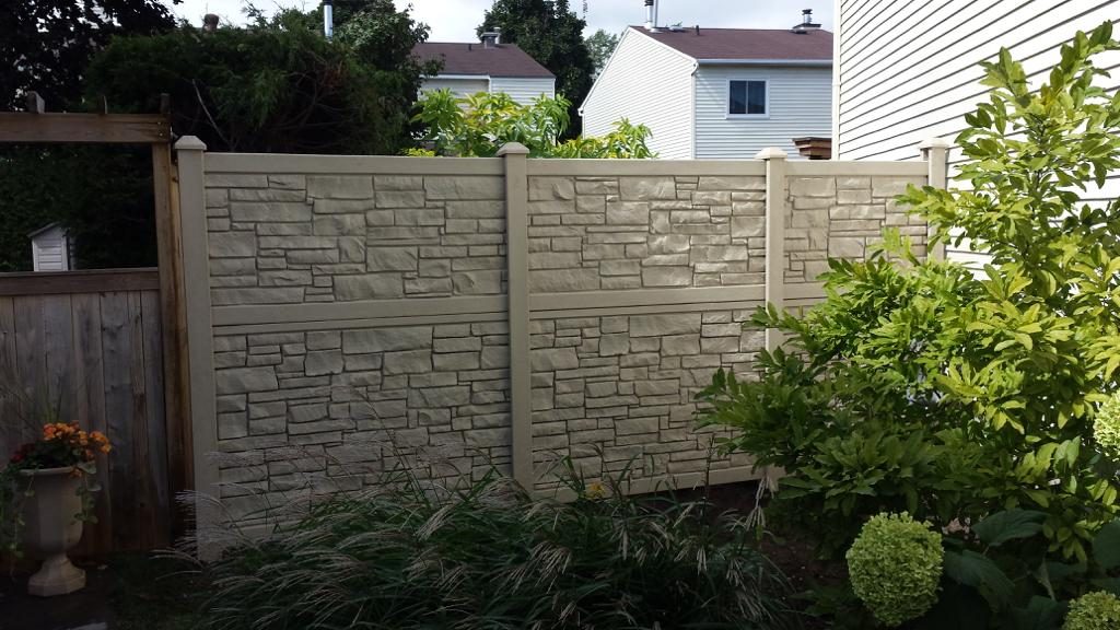 A simtek fence, offering numerous benefits, divides residential properties with a well-maintained garden in the foreground.