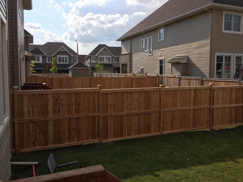 A wooden fence in a backyard.