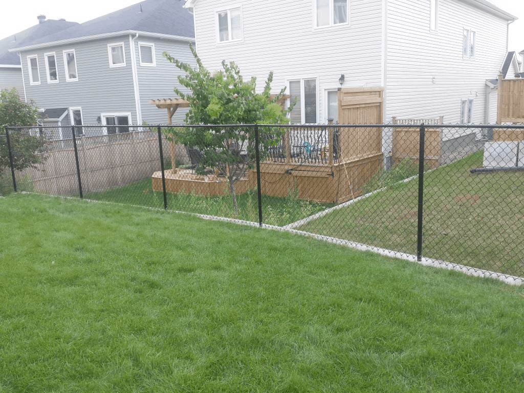 A backyard featuring a black chain link fence, Chain link fence installation, Chain-Link Fencing