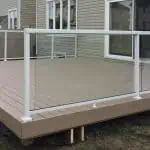 a wooden deck featuring a glass railing, constructed by deck builders in ottawa.