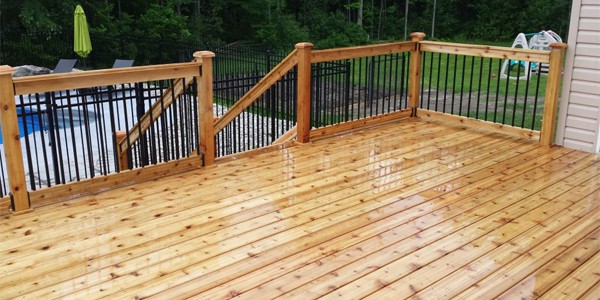 Looking for experienced deck builders in Ottawa to construct a wooden deck with a railing and possibly a pool for your backyard oasis.