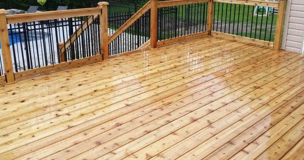 freshly stained wooden deck with fencing and railing, fencing and decks