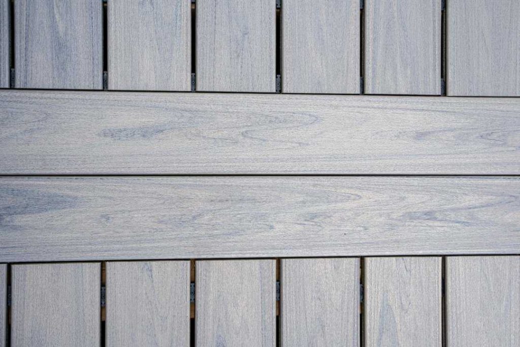 Wooden deck flooring with a horizontal plank pattern.