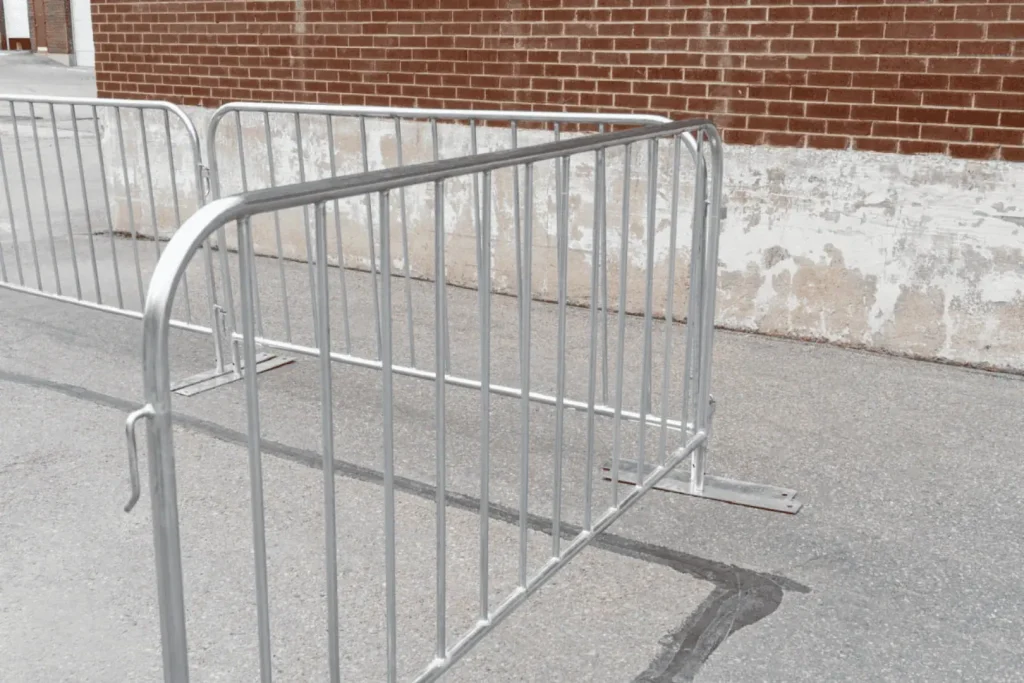 interlock paving in ottawa beautifully complements the metal barricades placed on a concrete surface near a brick wall, construction fence rental ottawa