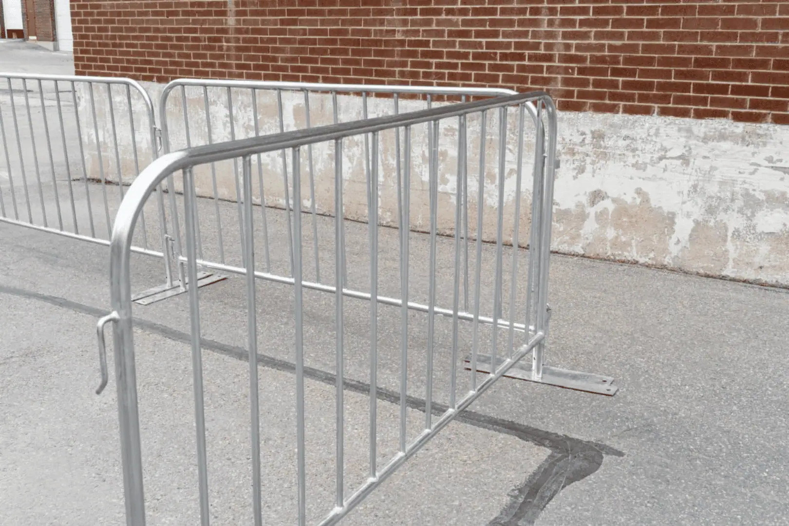 interlock paving in ottawa beautifully complements the metal barricades placed on a concrete surface near a brick wall, construction fence rental ottawa, event fencing rental ottawa